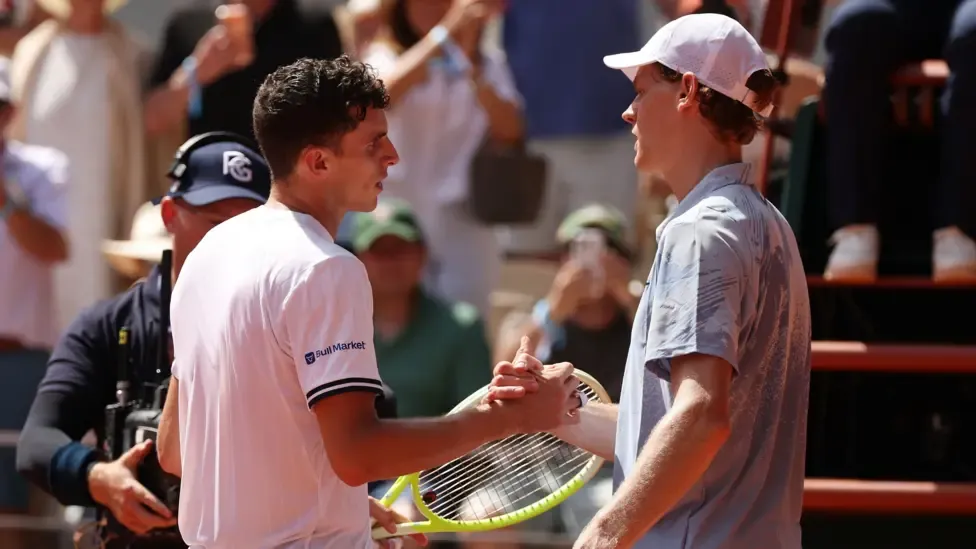 Juan Manuel Cerundolo and Jannik Sinner shake hands at the end of their second-round match at the French Open