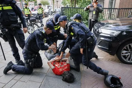 Police make an arrest in The Hague after the match.