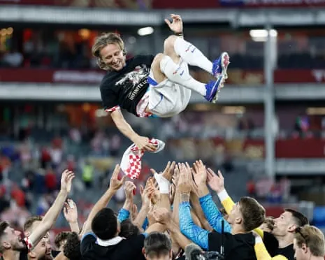Luka Modric is thrown in the air by his teammates after victory in his 200th game for Croatia.