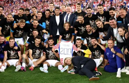Luka Modric celebrates with teammates after earning his 200th cap