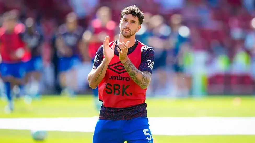 Marcos Senesi applauds the Bournemouth fans.