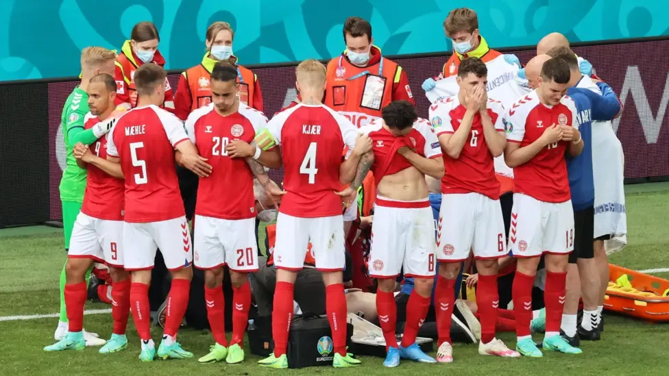 Players from Denmark form a collective ring to shield their teammate Christian Eriksen as he receives medical assistance during the UEFA EURO 2020 Group B match between Denmark and Finland in Copenhagen, Denmark, on 12 June 2021.