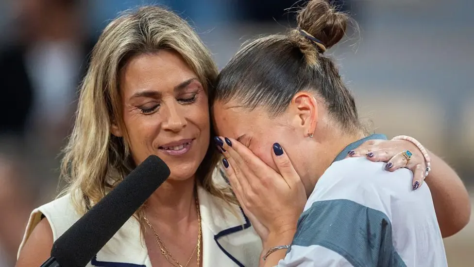 Marta Kostyuk is consoled by former Wimbledon champion Marion Bartoli during her post-match interview