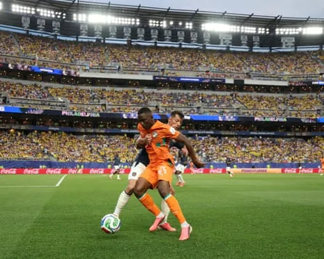 Bazoumana Toure of Cote d'Ivoire controls the ball against Alan Franco.