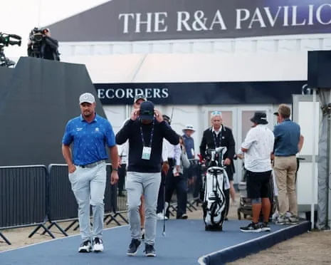 Bryson DeChambeau (left) departs scoring after being handed a two-shot penalty.