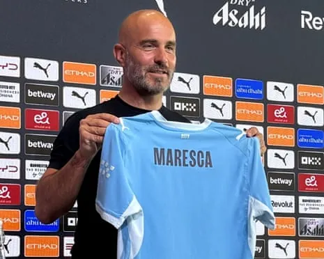 Enzo Maresca holds a Manchester City shirt with his name on at his first press conference as the club's manager on Friday.