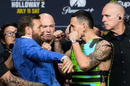 Conor McGregor (left) and Max Holloway face off at Thursday’s press conference in Las Vegas.
