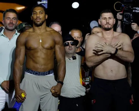 Anthony Joshua (left) and Kristian Prenga weigh in the before their heavyweight showdown in Jeddah.